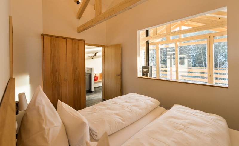 Im Schlafzimmer des Forstgut Chalets genießen Sie den Blick in die Natur des Bayerischen Waldes